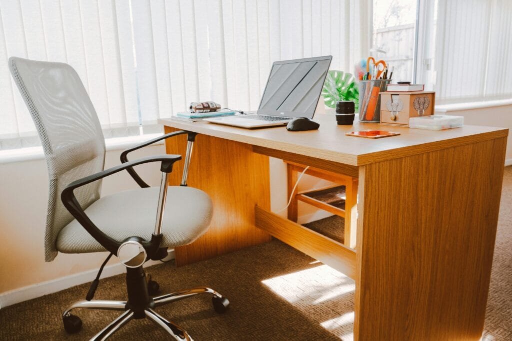 "A clean workspace with a laptop, planner, and a board with inspirational quotes, bright and organized" Keywords: workspace, organized, productive