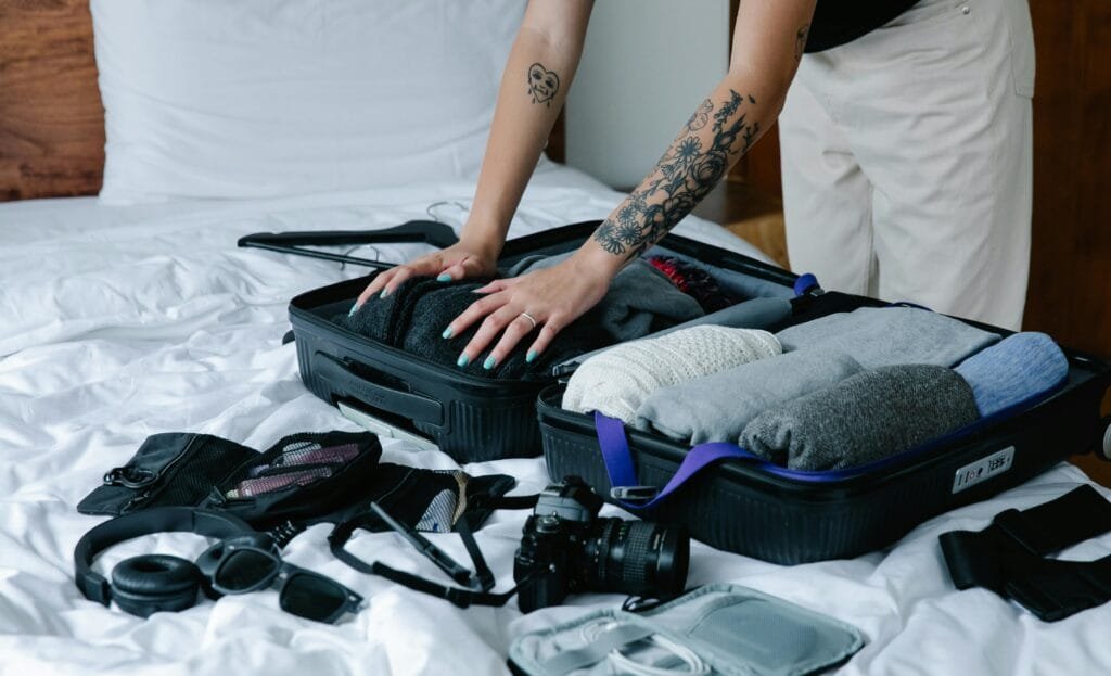 "A neatly packed suitcase with travel essentials like passport, sunglasses, and camera" Keywords: travel, essentials, organized